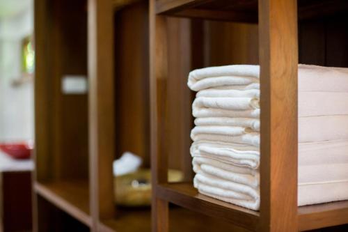 a stack of towels in a closet at Suksatan Lamphun in Lamphun