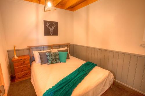 a bedroom with a bed with pillows on it at Drovers Rest in Dinner Plain