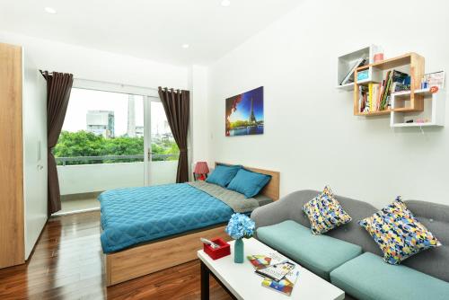 a living room with a couch and a bed at Sunrisehome in Ho Chi Minh City