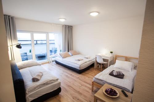 a living room with a bed and a couch at Haas Apartments Stojanova with Parking in Brno