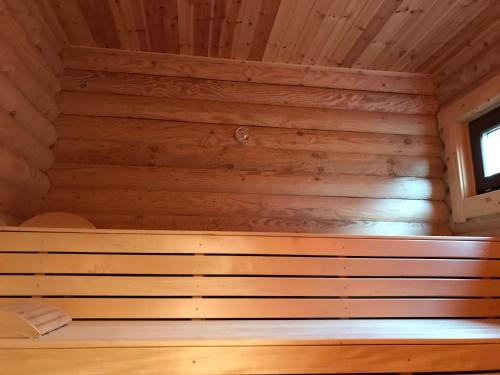 a wooden room with a bench in a cabin at Wellness Hütte am Zwenkauer See bei Leipzig in Zwenkau