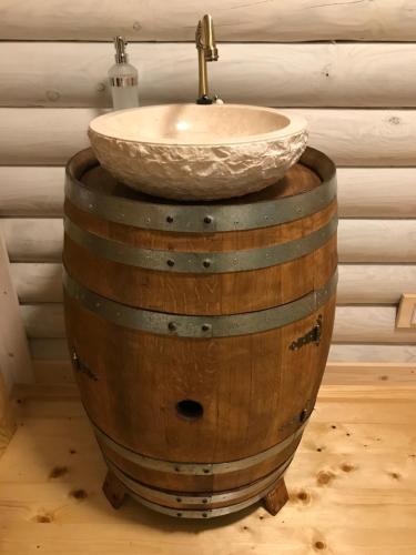 a sink on top of a wooden barrel with a sink on top at Wellness Hütte am Zwenkauer See bei Leipzig in Zwenkau
