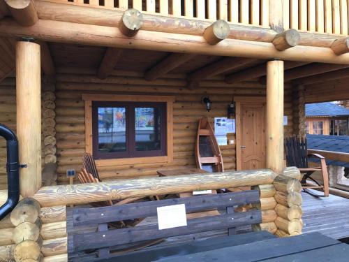 a log cabin with a bench and a window at Wellness Hütte am Zwenkauer See bei Leipzig in Zwenkau