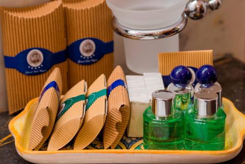 a tray with chopsticks and bottles of detergent and other items at Grand Hotel Wagner in Palermo