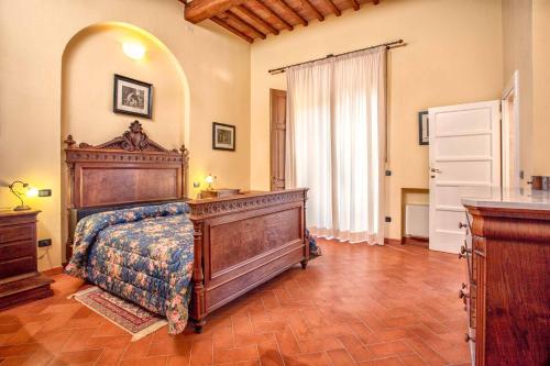 a bedroom with a large wooden bed in a room at Villa Graziani in Vada