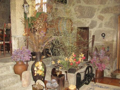 a group of vases and flowers in a room at Quinta Formosa in Vale Formoso