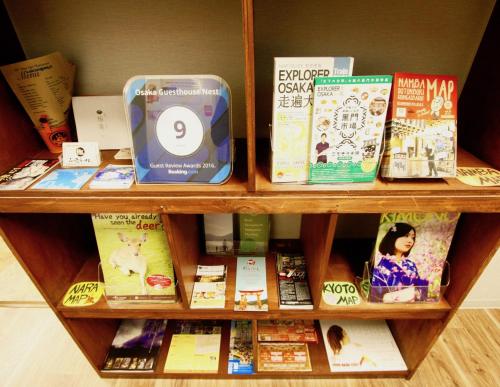 a book shelf filled with lots of books at Osaka Guesthouse Nest in Osaka