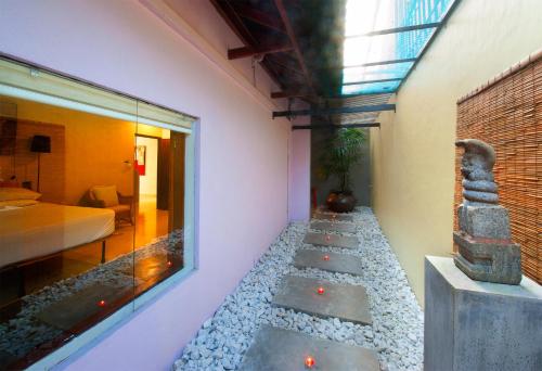 a room with a rock pathway leading to a bedroom at Dickman Resort "The Boutique Hotel" in Negombo