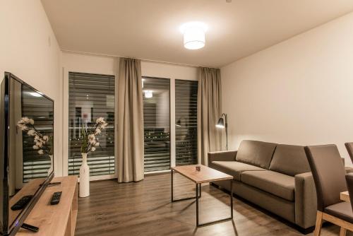 a living room with a couch and a table at Appartements Ausblick in Sankt Gallenkirch