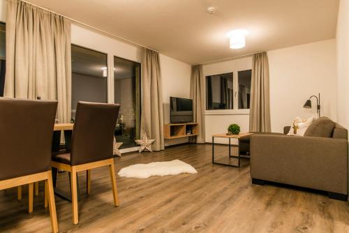 a living room with a couch and a table at Appartements Ausblick in Sankt Gallenkirch