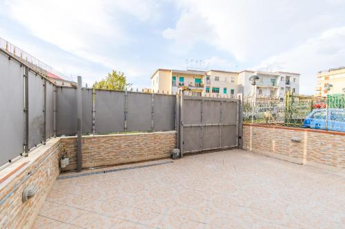 a patio with a fence and a brick wall at B&b Il miglio d’oro in Ercolano