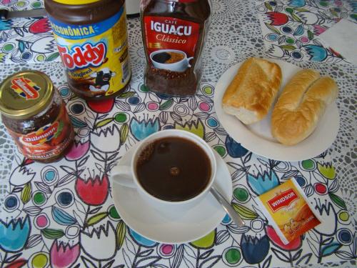 a table with a cup of coffee and a plate of croissants at Sur Backpackers in Santa Cruz de la Sierra