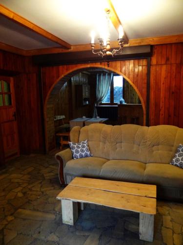 a living room with a couch and a table at Schody Do Nieba in Zakopane