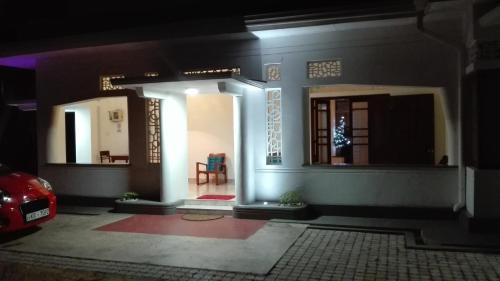 a house with a car parked in front of it at Crescent N Cocoon in Ambalangoda