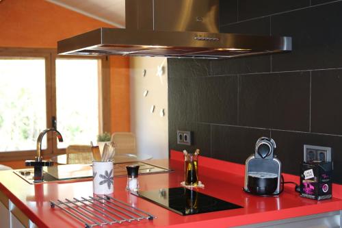 a kitchen with a red counter top with a stove at Casablanca in Badalona