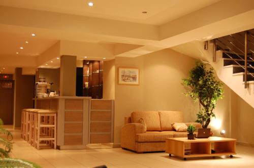 a living room with a couch and a table at Hotel Antirriο in Antirrio