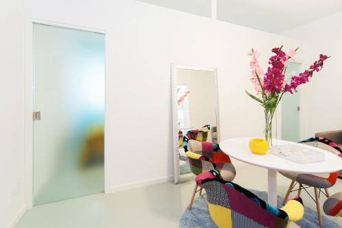 a room with a table and a vase of flowers at Casa Bella Pantheon in Rome
