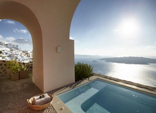 a villa with a swimming pool and a view of the ocean at Villa Bordeaux in Fira