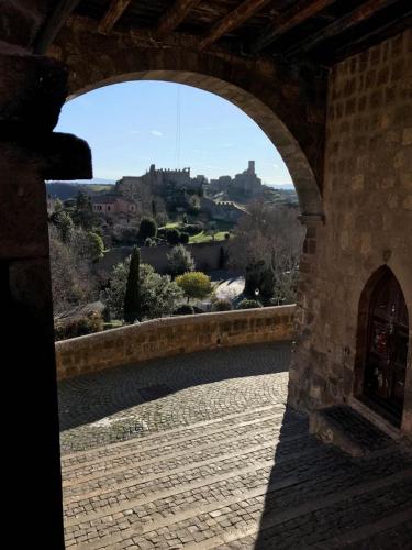 an archway in a building with a view of a city at La Terrazza in Tuscania