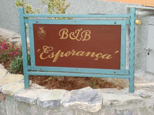a sign for a restaurant on a stone wall at B&B Esperança in Frascineto