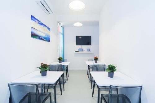 a dining room with tables and chairs and a tv at Casa Bella Pantheon in Rome