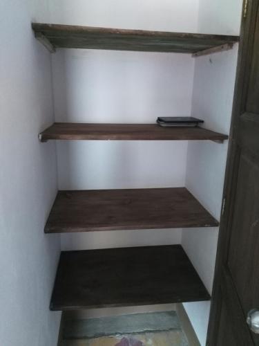 a closet with wooden shelves in a room at Sergeant Pepper's Hostel in Jardin