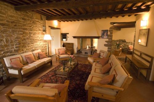a large living room with couches and a fireplace at Castello Di Gargonza in Monte San Savino