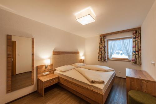 a bedroom with a large bed and a window at Ferienhaus Larinmos in Lermoos