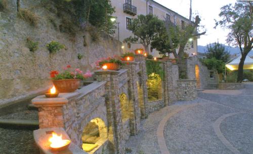 a stone wall with candles on a street at Villa San Domenico in Morano Calabro