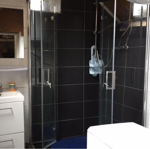 une salle de bain avec une douche en verre et des toilettes dans l'établissement An ti Bihan, Gite Breton à la campagne, à Tonquédec