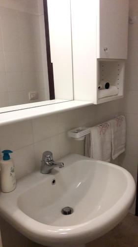 a white sink in a bathroom with a mirror at Mini Chic Downtown in Bologna