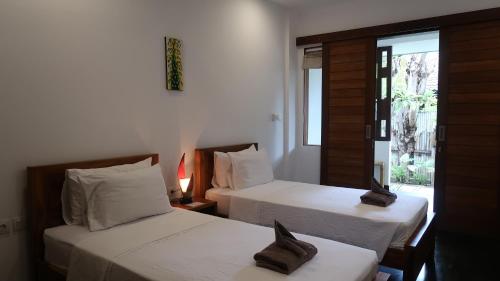 Voodi või voodid majutusasutuse Dream Divers Resort toas
