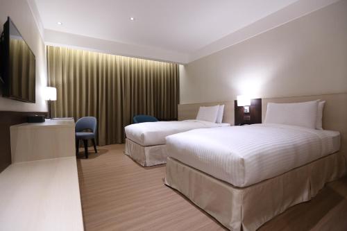 Postel nebo postele na pokoji v ubytování Full Kind Hotel