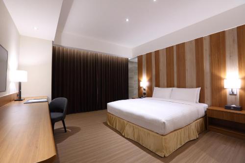 Ένα ή περισσότερα κρεβάτια σε δωμάτιο στο Full Kind Hotel