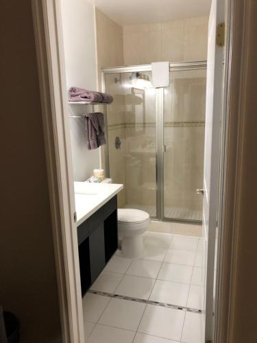 a bathroom with a shower and a toilet and a sink at Knights Inn Los Angeles Central / Convention Center Area in Los Angeles