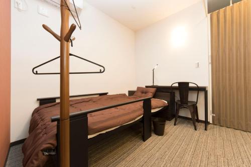 a bedroom with a bed and a desk and a table at Ryoma Ikebukuro in Tokyo