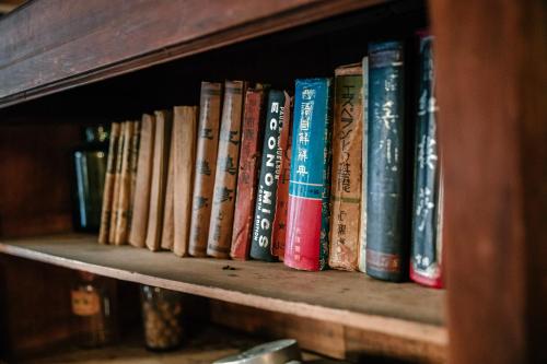 a row of books sitting on a book shelf at 84 In Tainan in Tainan