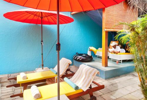 a patio area with a table, chairs and umbrellas at Dickman Resort "The Boutique Hotel" in Negombo
