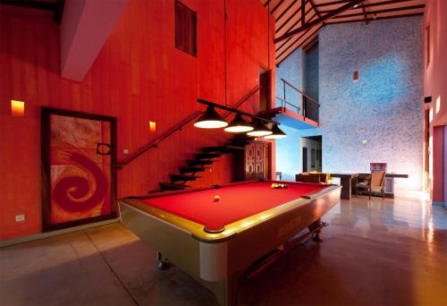 a pool table in a room with a staircase at Dickman Resort "The Boutique Hotel" in Negombo