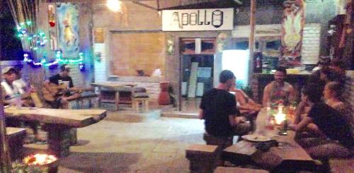 a group of people sitting in a restaurant at Apollo Hostel in Lovina