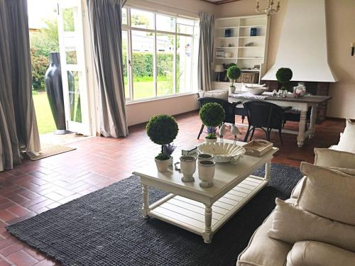a living room with a couch and a table at Oude Berg Guesthouse - 10 Caledon Street in George