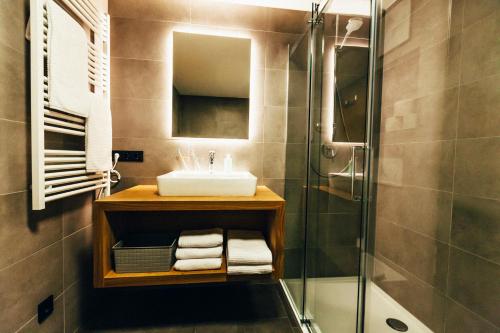 ein Bad mit einem Waschbecken und einer Dusche in der Unterkunft Riefli Aparts in Sankt Anton am Arlberg