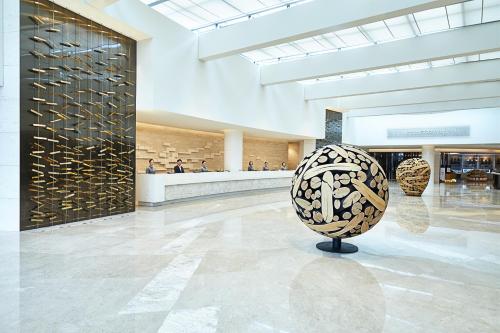 a lobby with a donut sculpture in the middle at Landing Jeju Shinhwa World Hotel in Seogwipo