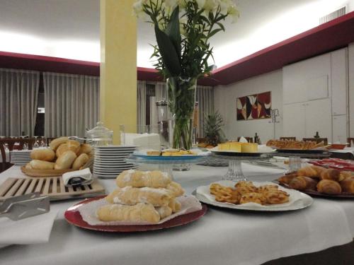 a table topped with plates of bread and pastries at San Marco in Montecchio Maggiore