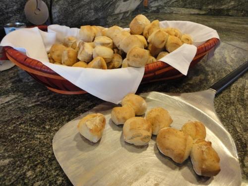 a bowl of food with a basket of bread at San Marco in Montecchio Maggiore