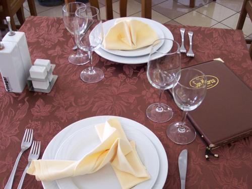 a table with white plates and wine glasses on it at San Marco in Montecchio Maggiore