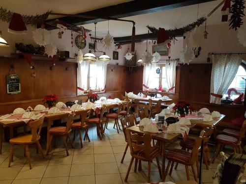 a dining room with tables and chairs and christmas decorations at Landgasthof zum Brückenwirt in Starnberg