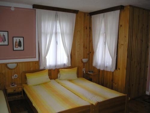A bed or beds in a room at Guest House Bolyarka