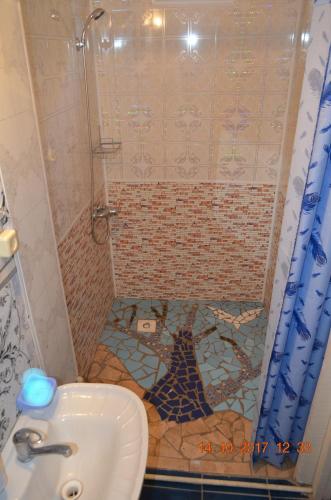 a bathroom with a shower with a toilet and a sink at Petrovskaya Pristan in Cholpon-Ata