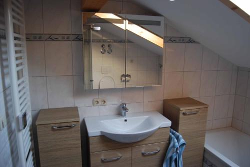 a bathroom with a sink and a mirror at Ferienwohnung Familie Schweiger in Ramsau